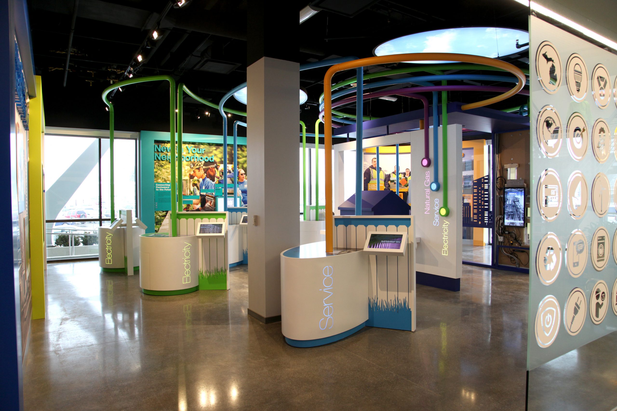 Exhibit stations with illuminated text highlighting Natural Gas, Energy and Services