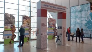 Arch in large atrium space that reads Spirit of the Marathon- background has wall displays with text