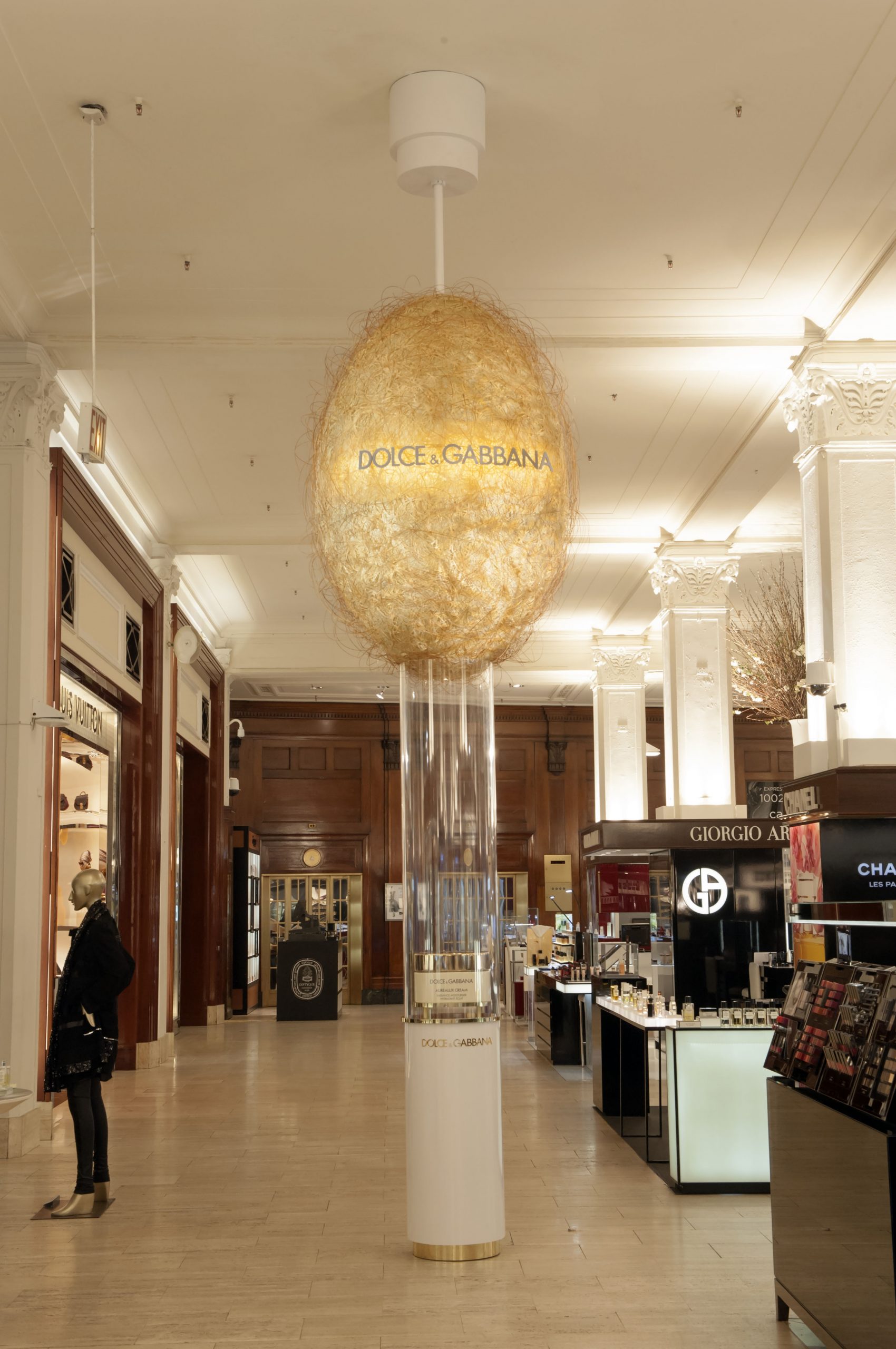 Interior of store with large hanging sculptural display made of gold material