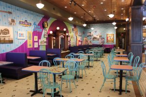 Exhibit area set up as an ice cream parlor with tables and chairs